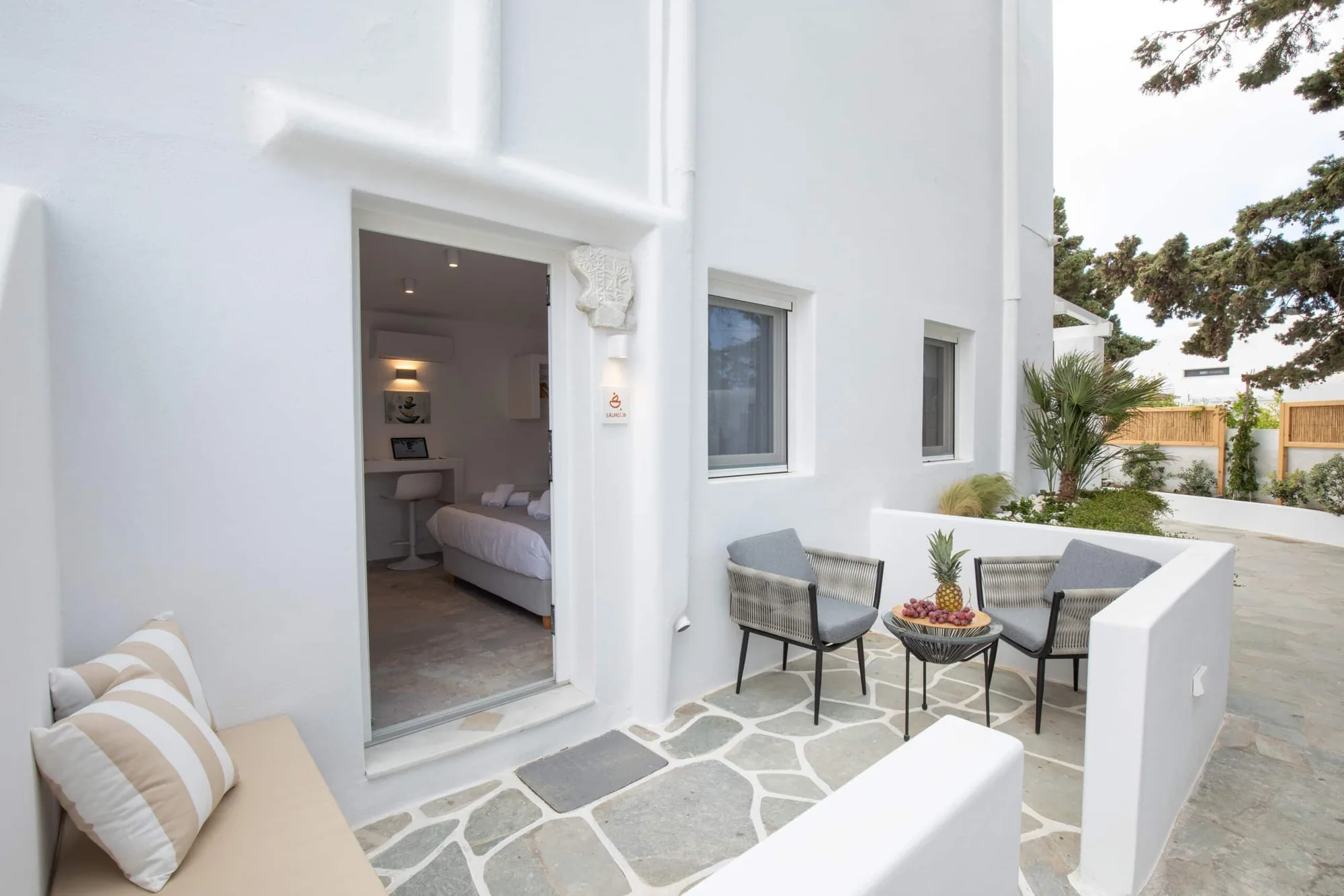 Double Room with Patio · Private patio with seating and a view into the room